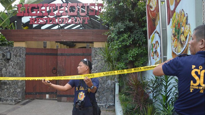 Police mark the crime scene with yellow tape where two Chinese diplomats were killed in Cebu