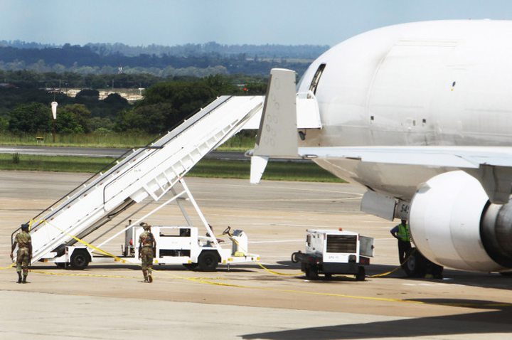 Zimbabwean soldiers patrol the seized cargo jet at Harare International Airport on Monday...