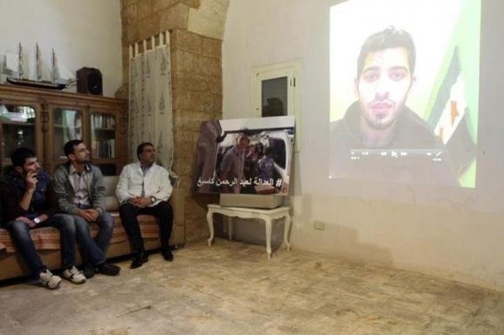 A former colleague of U.S. aid worker Abdul-Rahman Kassig, is seen on a projection screen ...
