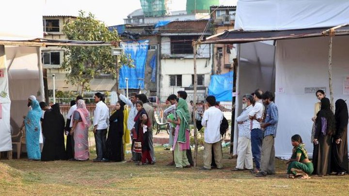 Indians stand in a queue to cast their votes at a polling station in Mumbai, India, Wednesday, Oct. 