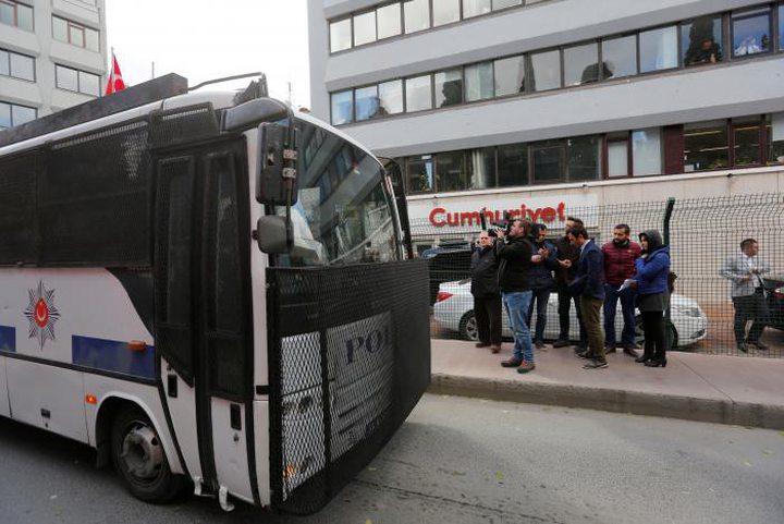 A police vehicle drives past by the headquarters of Cumhuriyet newspaper, an opposition secularist..