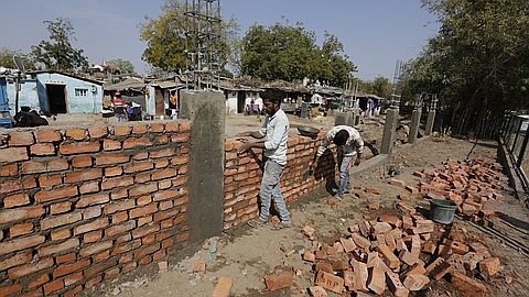 India hastily builds wall along slum ahead of Trump visit