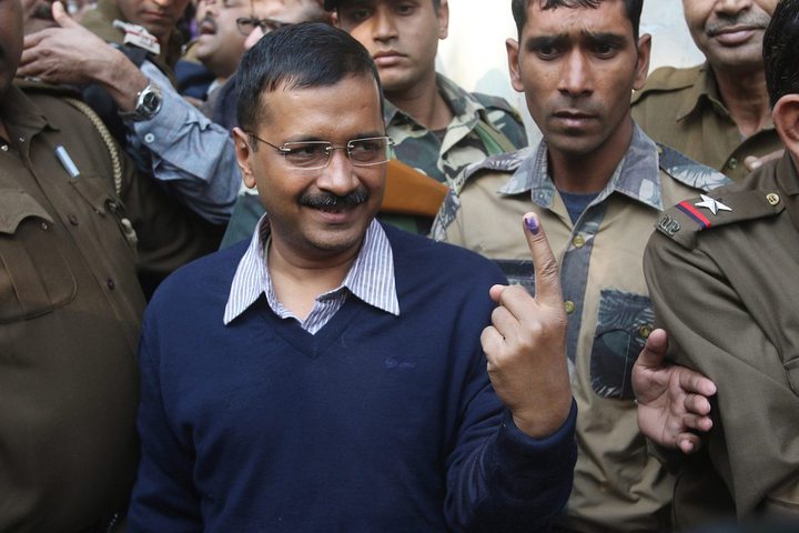 Aam Admi Party's Chief Ministerial candidate Arvind Kejriwal shows his ink-marked finger