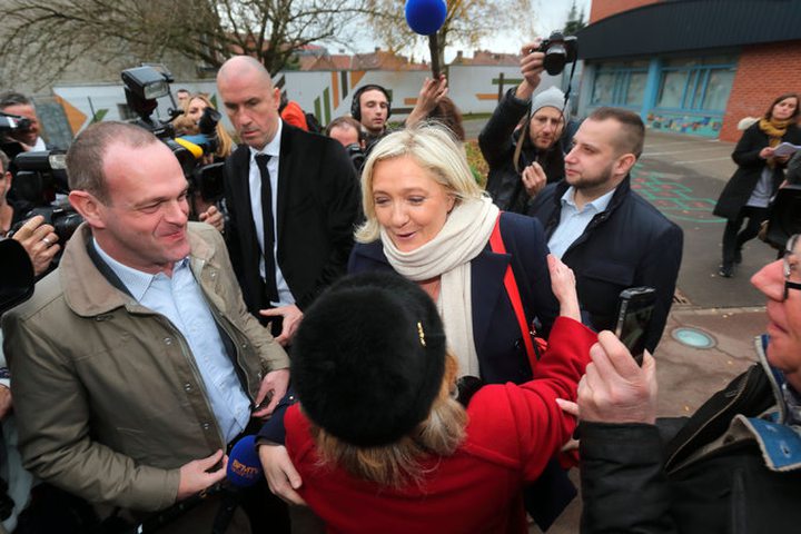 The leader of the National Front, Marine Le Pen, center, greeted supporters after voting Sunday