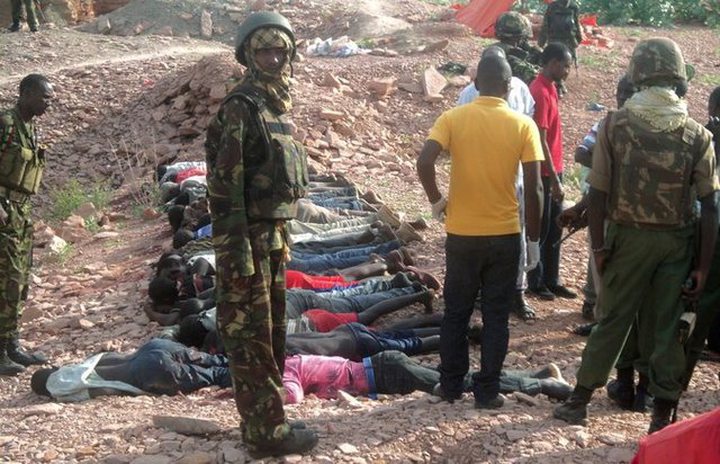 Troops standing over the victims of a massacre by Shabab militants in northern Kenya