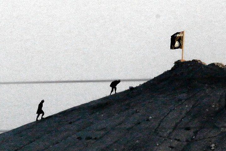 Islamic State fighters planted their flag near Ayn al-Arab, Syria, Monday, clearly visible ...