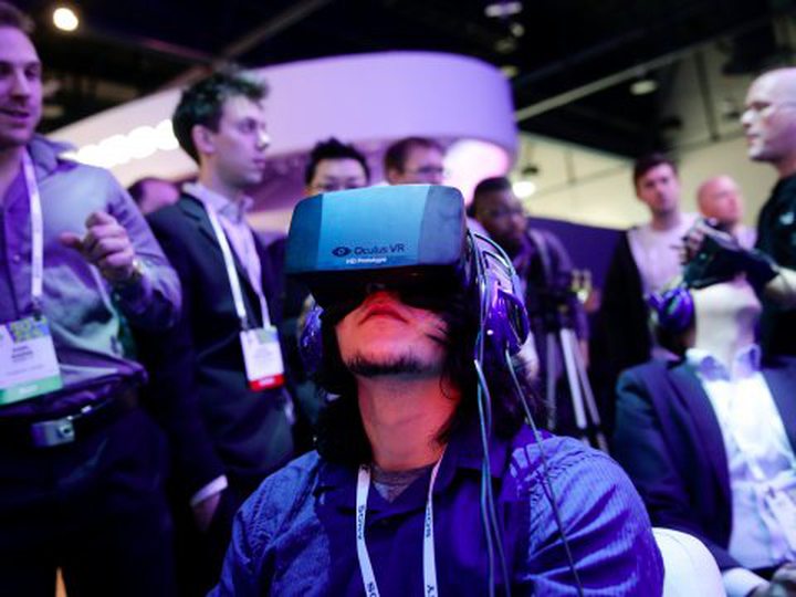 A man demos an early Oculus Rift prototype headset at the Consumer Electronics Show in Las Vegas