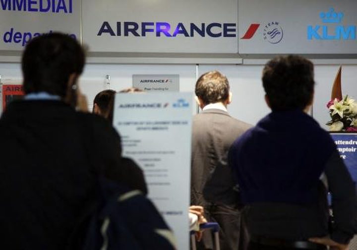 Passengers wait at check-in counters on the first day of an Air France one-week strike ...