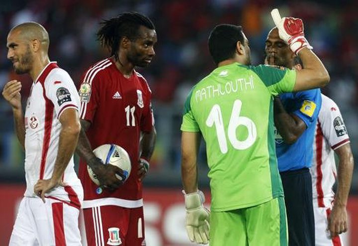 Equitorial Guinea's Javier Balboa (2nd L) looks on as Tunisia's Hamza Mathlouthi argues with referee