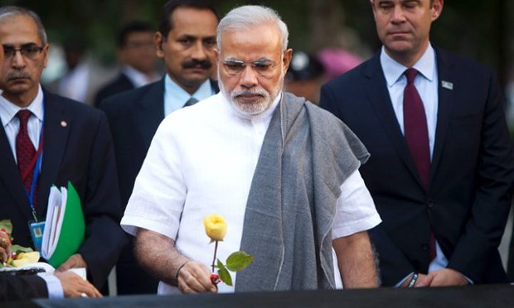 ndia’s Prime Minister Narendra Modi lays a yellow rose on the name of an Indian who died...
