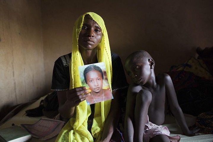 Rachel Daniel, 35, holds up a picture of her daughter Rose Daniel, 17, kidnapped by the Islamic ..
