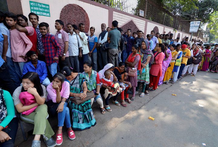 People waited to deposit their old high-denomination currency notes on Saturday outside a bank