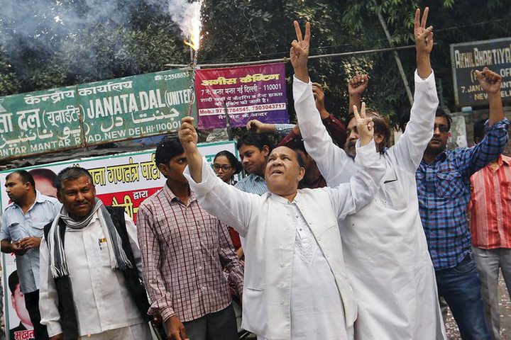 Members of the opposition alliance cheering Sunday outside a party office in New Delhi